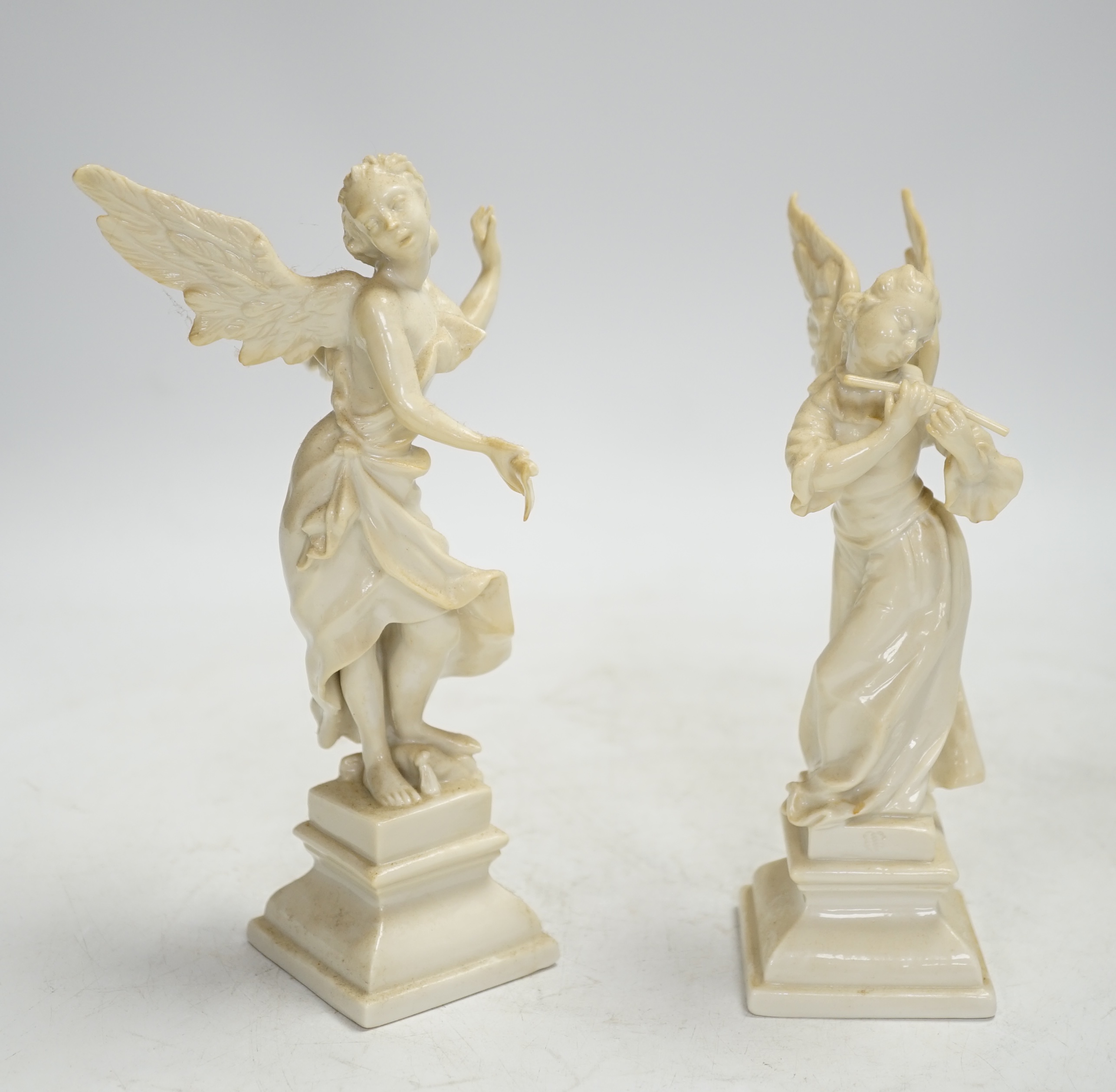 A pair of Nymphenburg white glazed figures of angels, tallest 18.5cm high. Condition - grubby, otherwise good